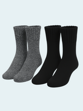 Two pairs of socks, one gray and one black, on a light gray background.