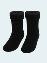Pair of black chennille socks on a light blue background