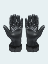 Pair of black leather gloves with fur cuffs on a light gray background