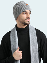 Man wearing a gray knit beanie and scarf on a white background