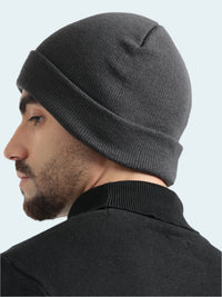 Man wearing a gray beanie against a white background