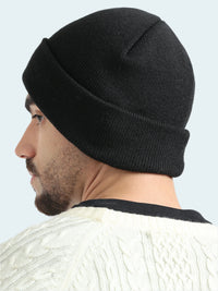 Person wearing a black beanie on a white background