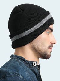 Man wearing a black beanie with a gray stripe on a white background