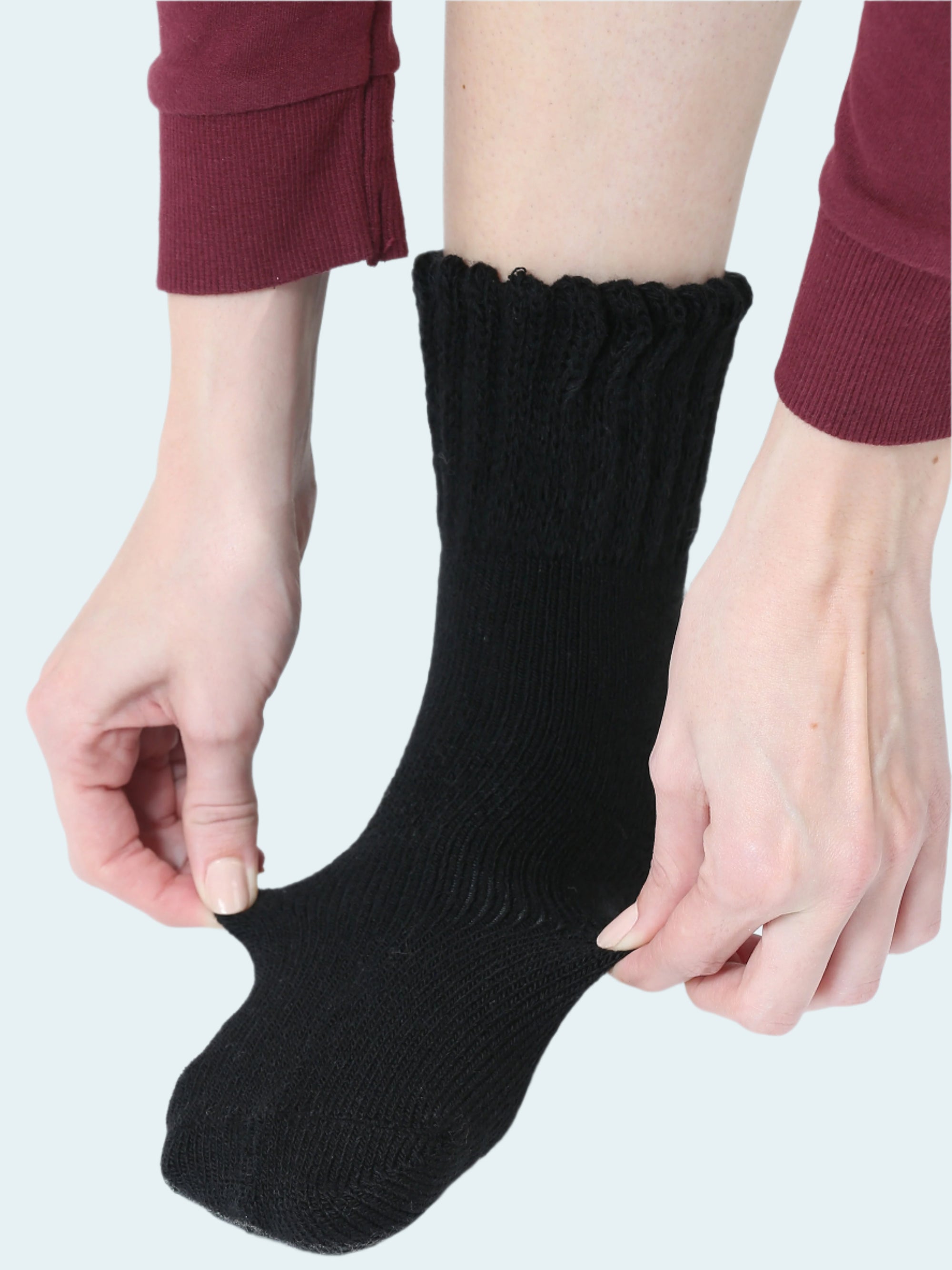 Person wearing a black sock on a white background