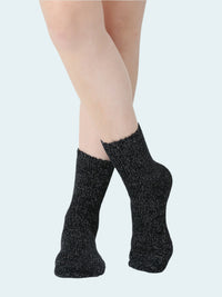 Womens Black chenille socks worn by a person on a white background