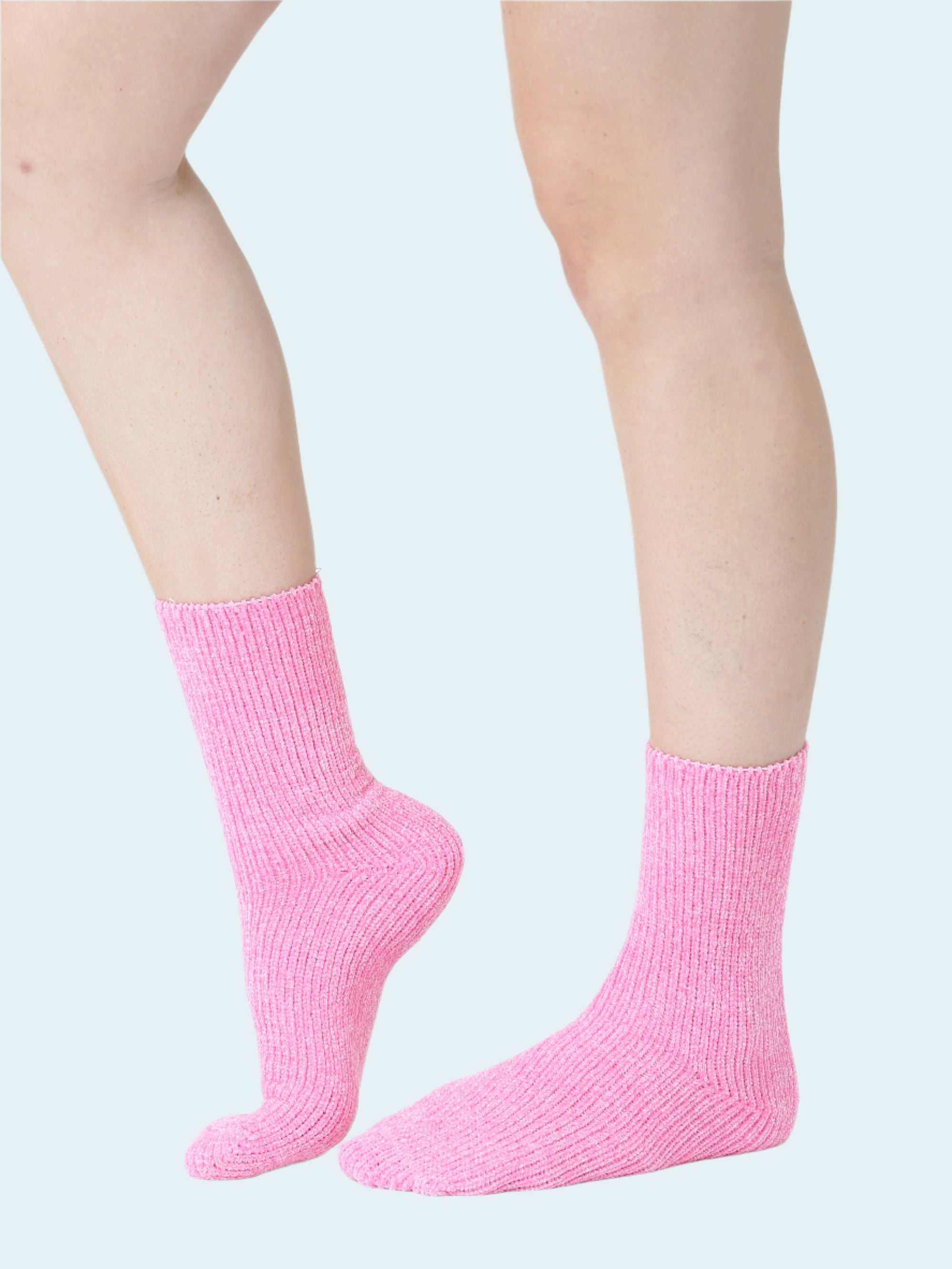 Pink socks worn by a person on a white background
