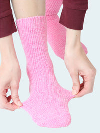 Person wearing pink socks with a white background