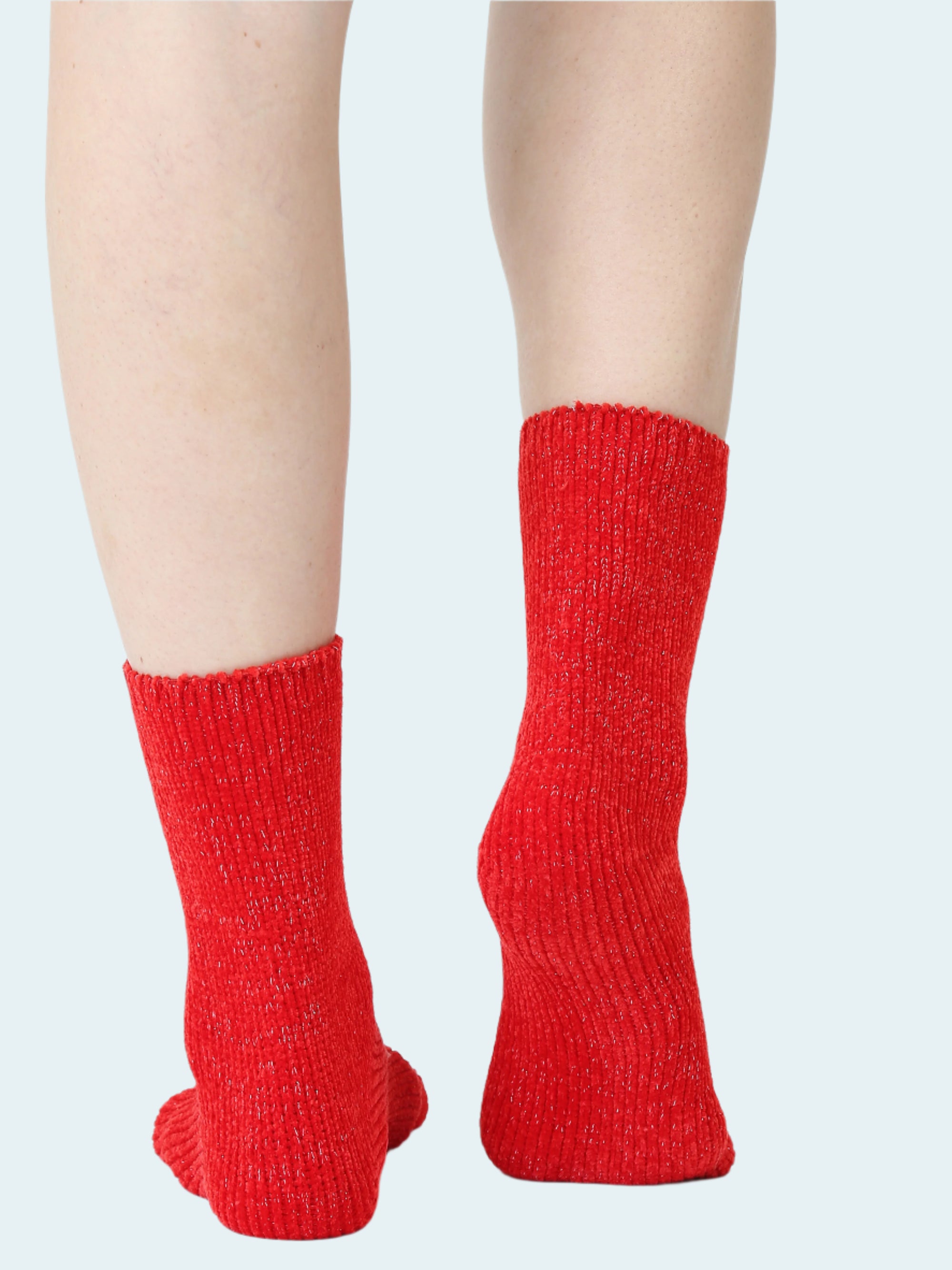 Red knitted socks worn on a white background