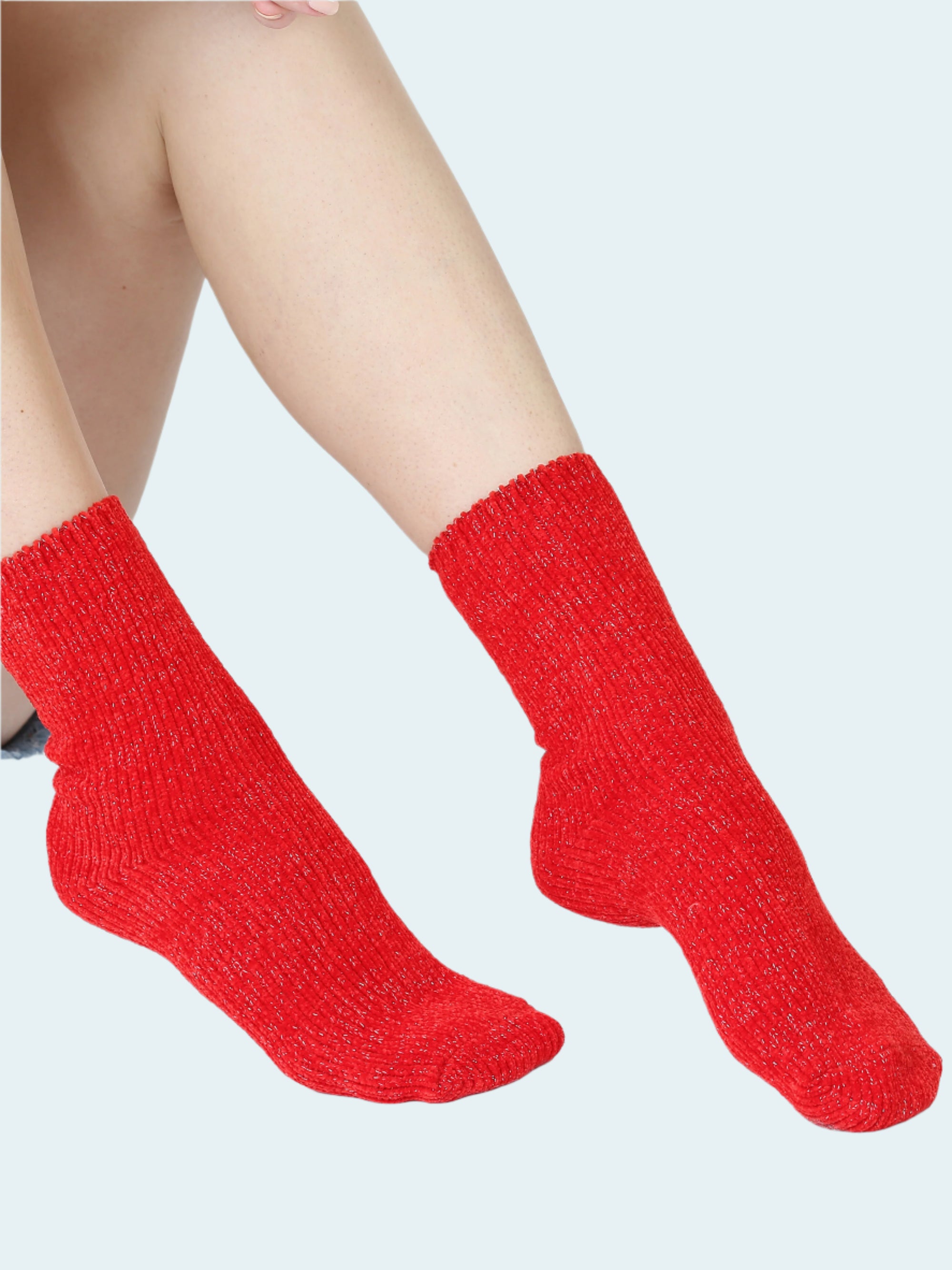 Red socks worn by a person on a white background