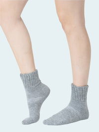 Gray socks worn by a person on a white background