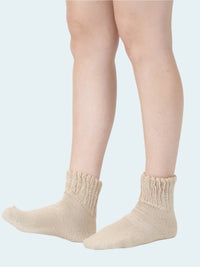 Beige socks worn by a person on a white background