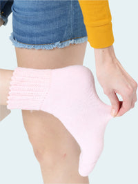 Person wearing a pink socks on a white background
