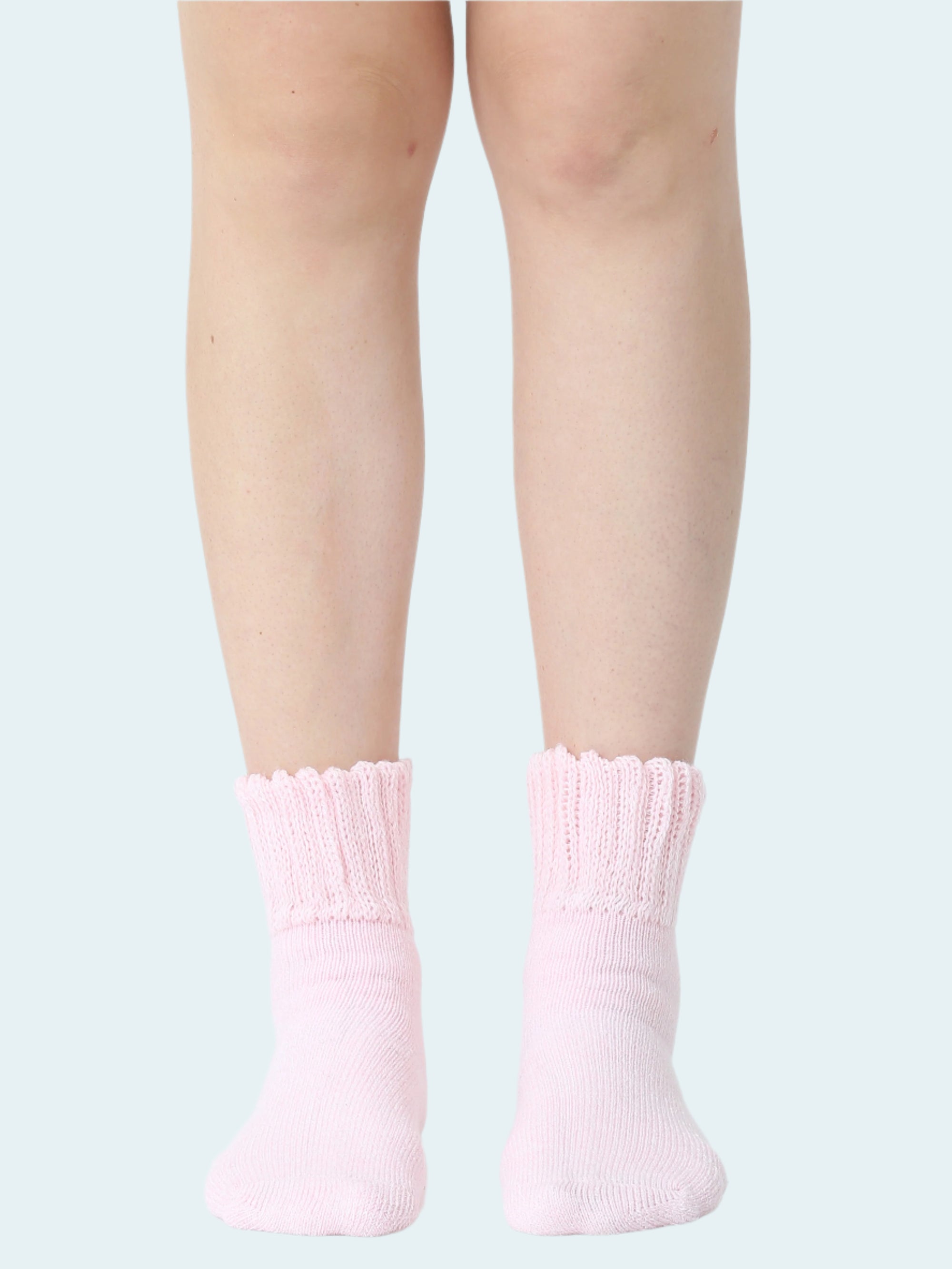 Pink socks worn by a person on a white background