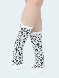 White knee-high socks with black leopard print worn by a person on a white background