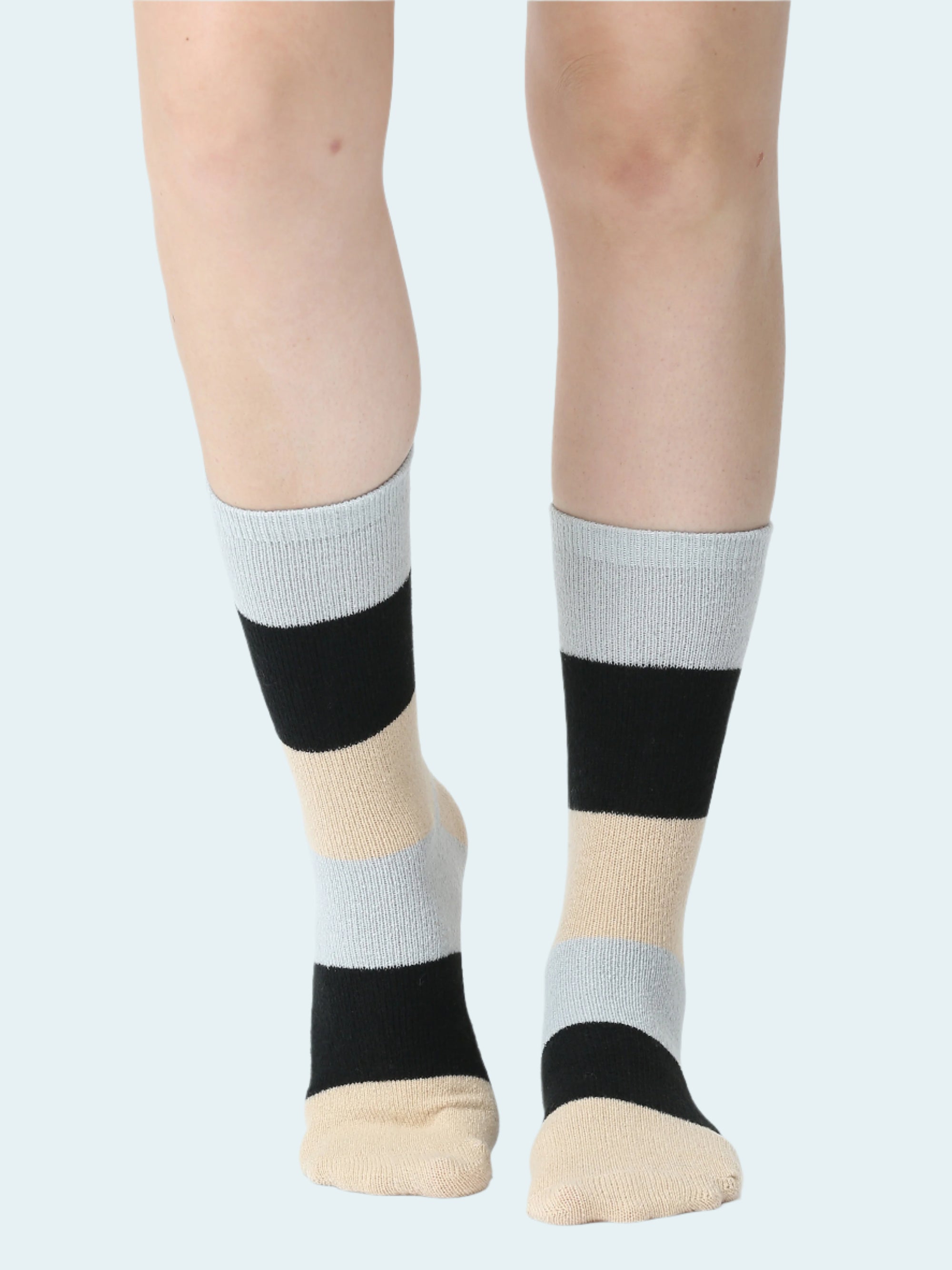 Color-blocked socks worn by a person on a white background