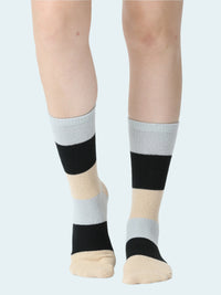 Color-blocked socks worn by a person on a white background