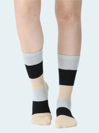 Color-blocked socks worn by a person on a white background