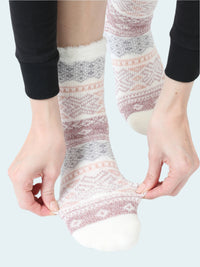 Person wearing patterned socks on a white background