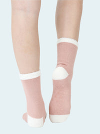 Pink socks with white accents worn by a person on a white background