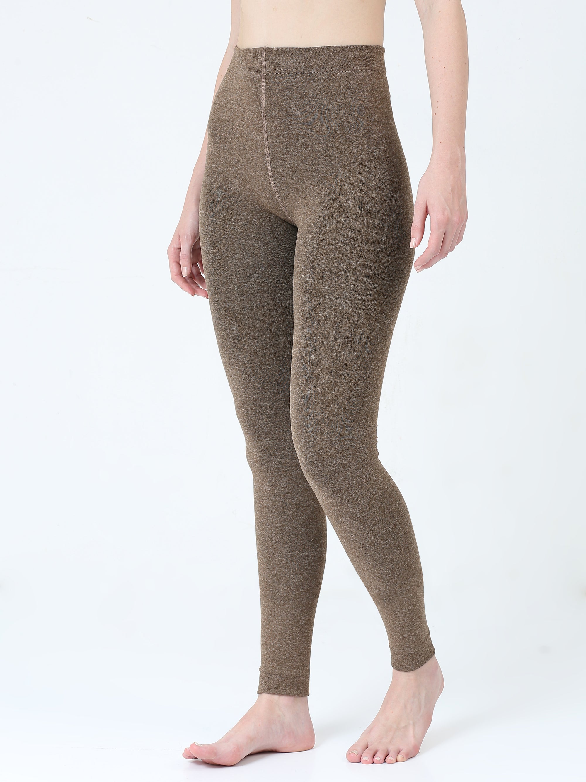 Brown leggings worn by a person on a white background