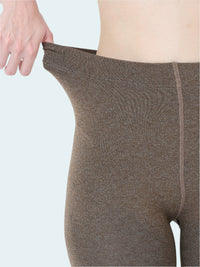 Brown leggings being worn on a white background