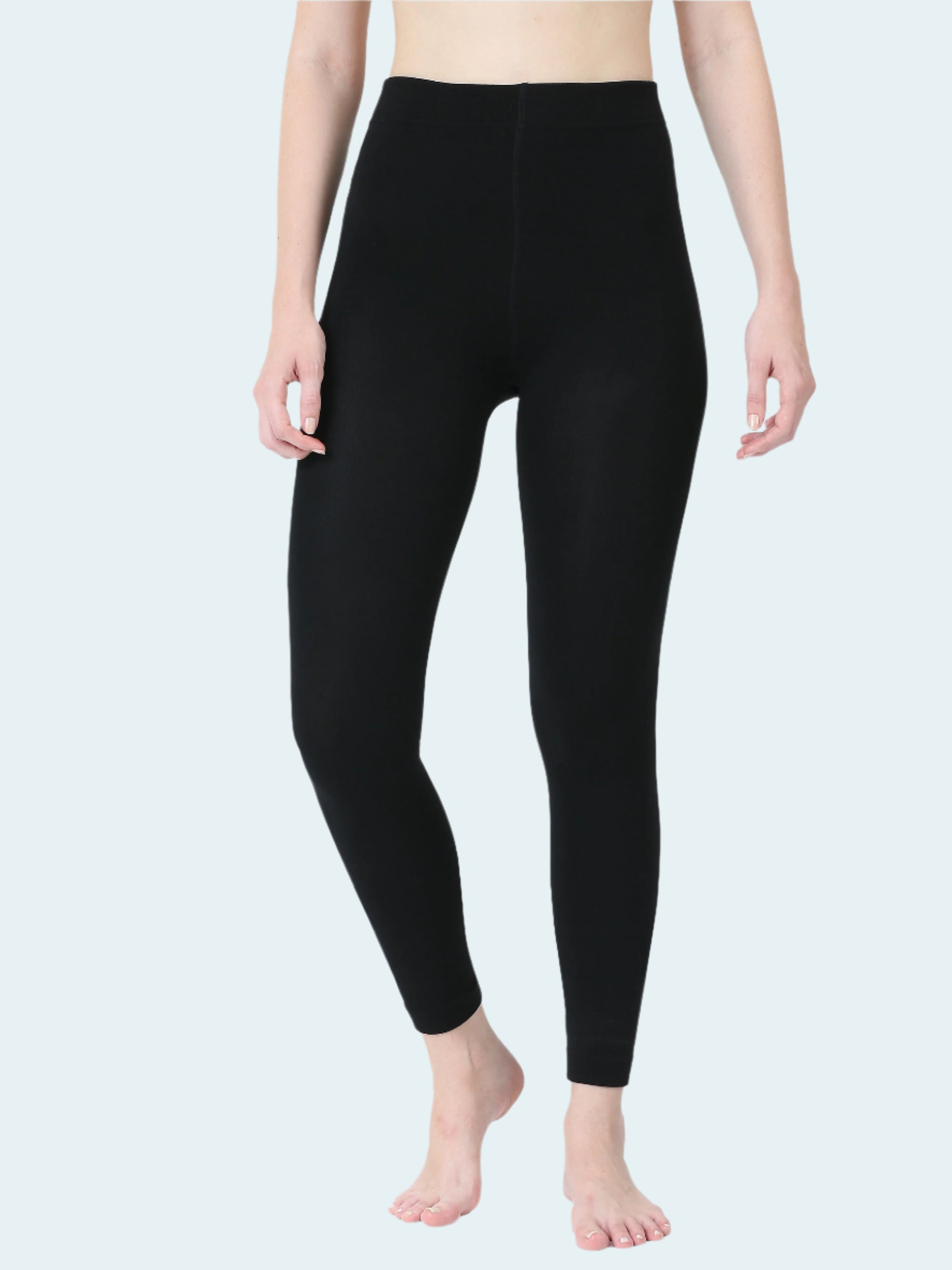 Person wearing black leggings on a white background