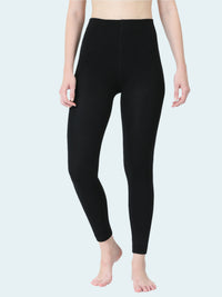 Person wearing black leggings on a white background