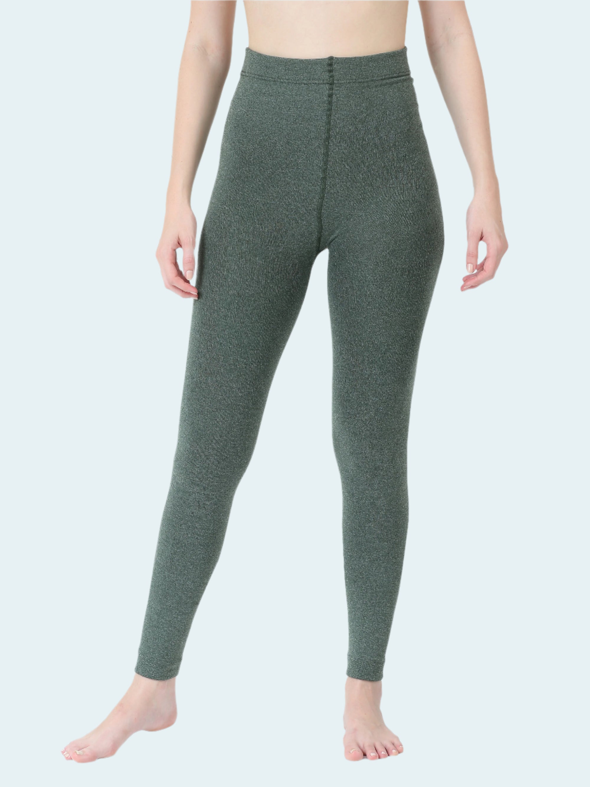 Person wearing green leggings on a white background