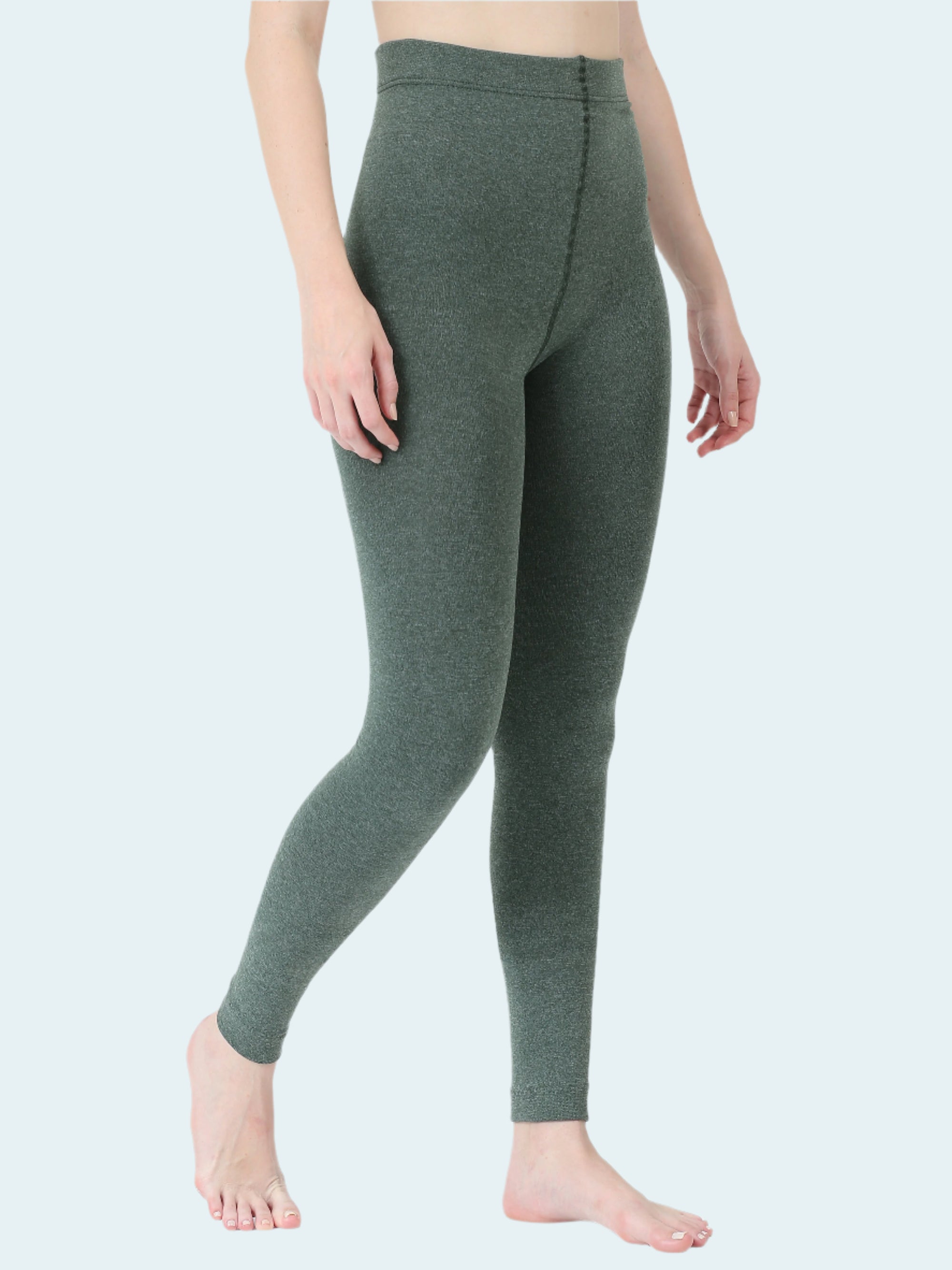 Person wearing green leggings on a white background