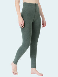Person wearing green leggings on a white background