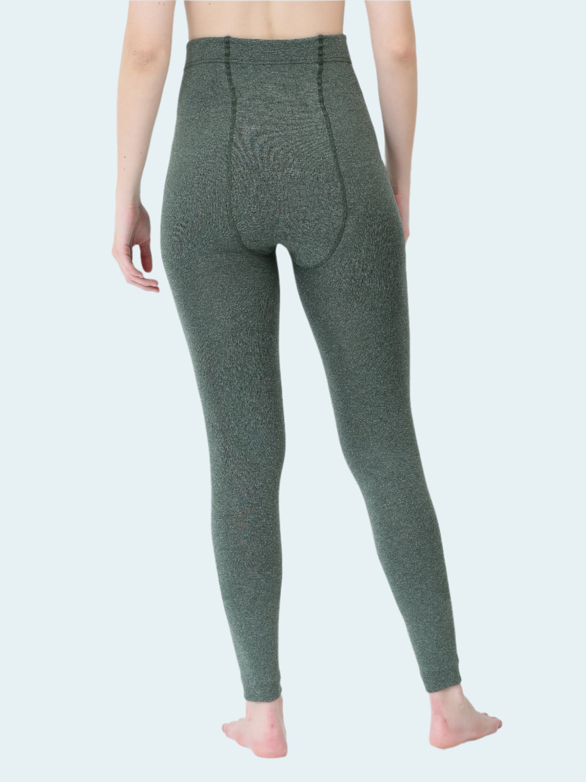 Person wearing green leggings on a white background