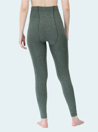 Person wearing green leggings on a white background