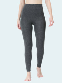 Person wearing dark gray leggings on a white background