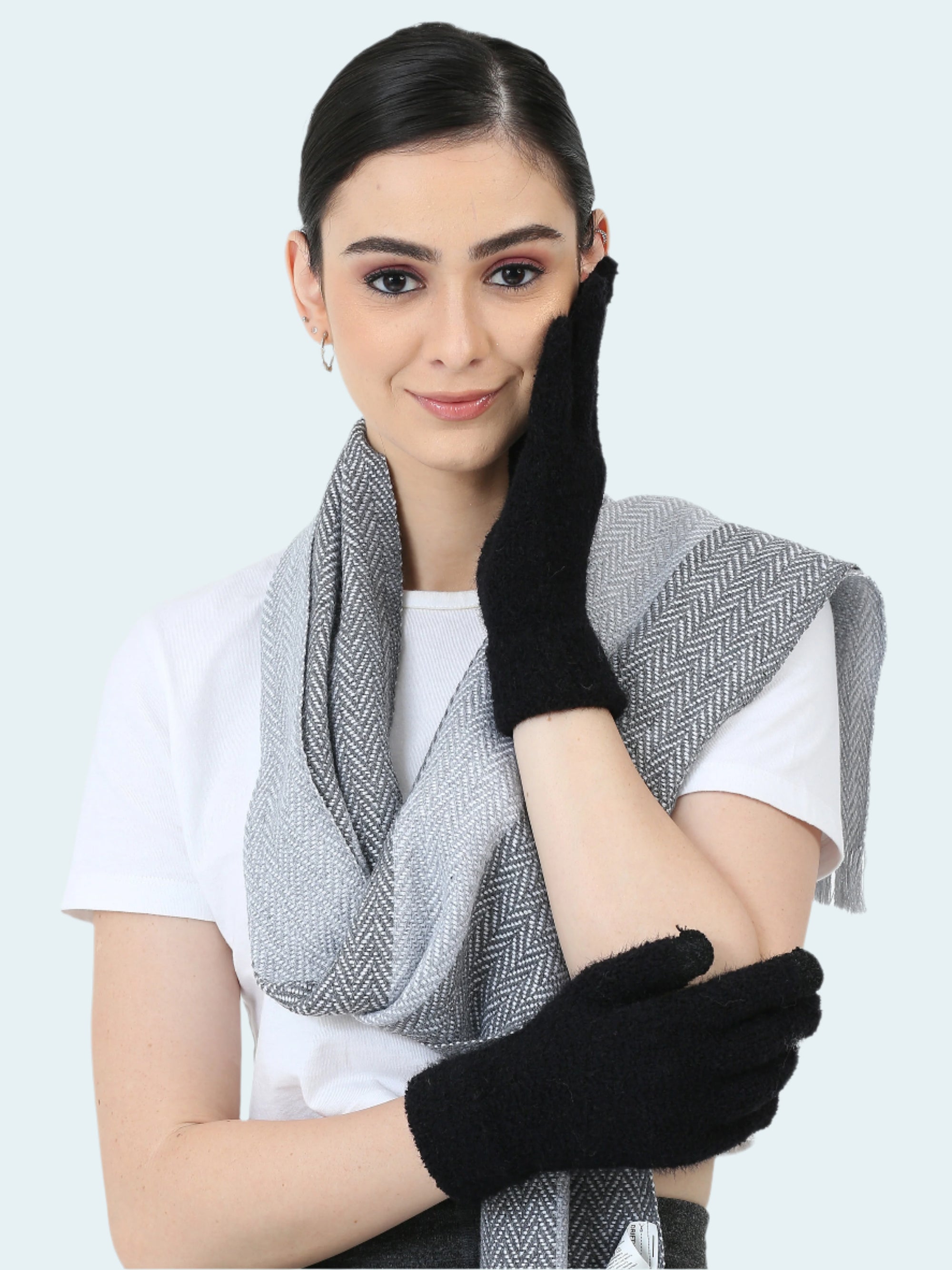 Woman wearing a gray scarf and black gloves on a white background