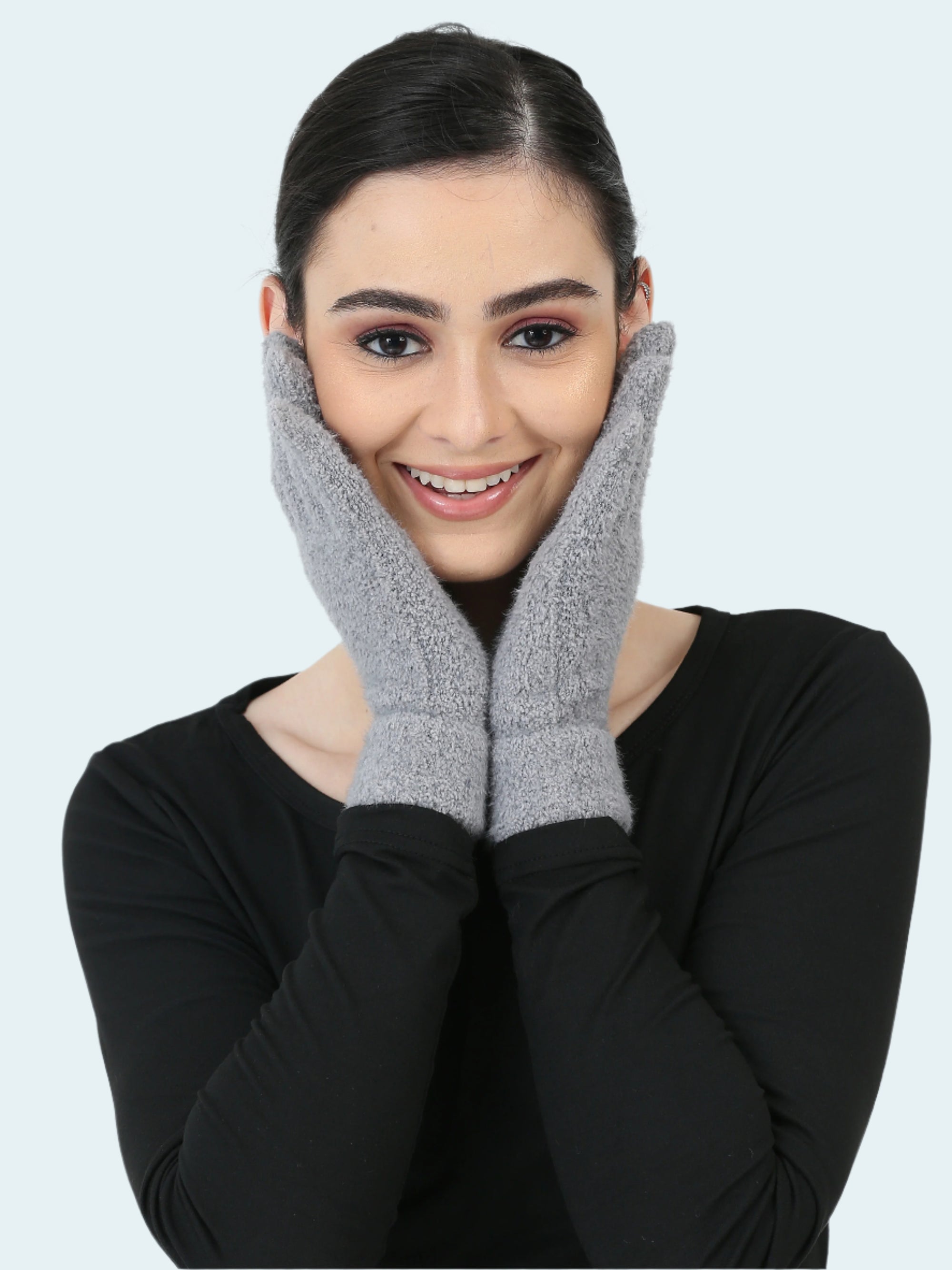 Woman wearing gray gloves on a white background