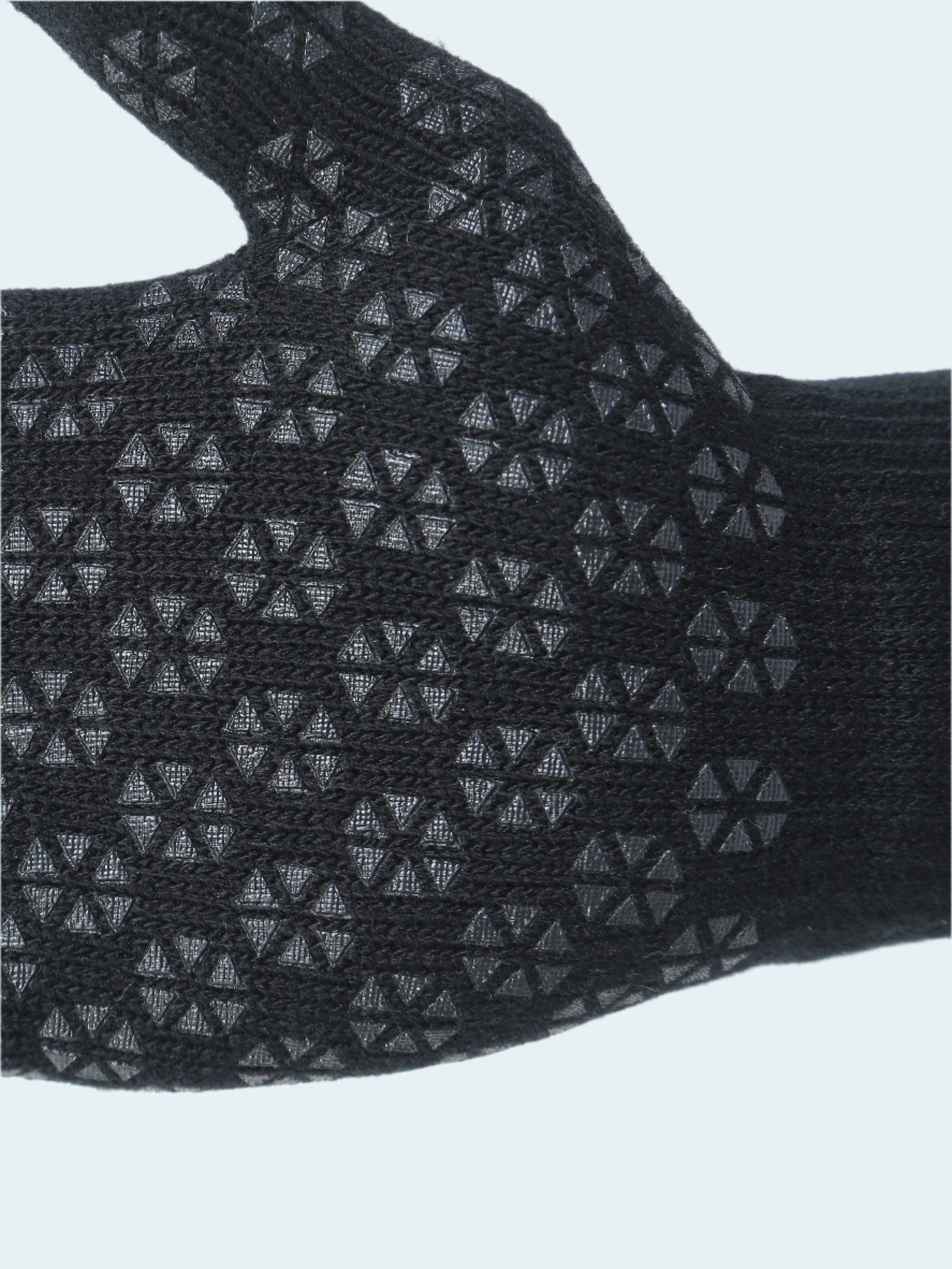 Black glove with textured pattern on a white background