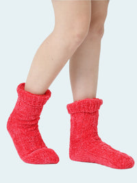Red knitted chenille socks worn by a person on a white background