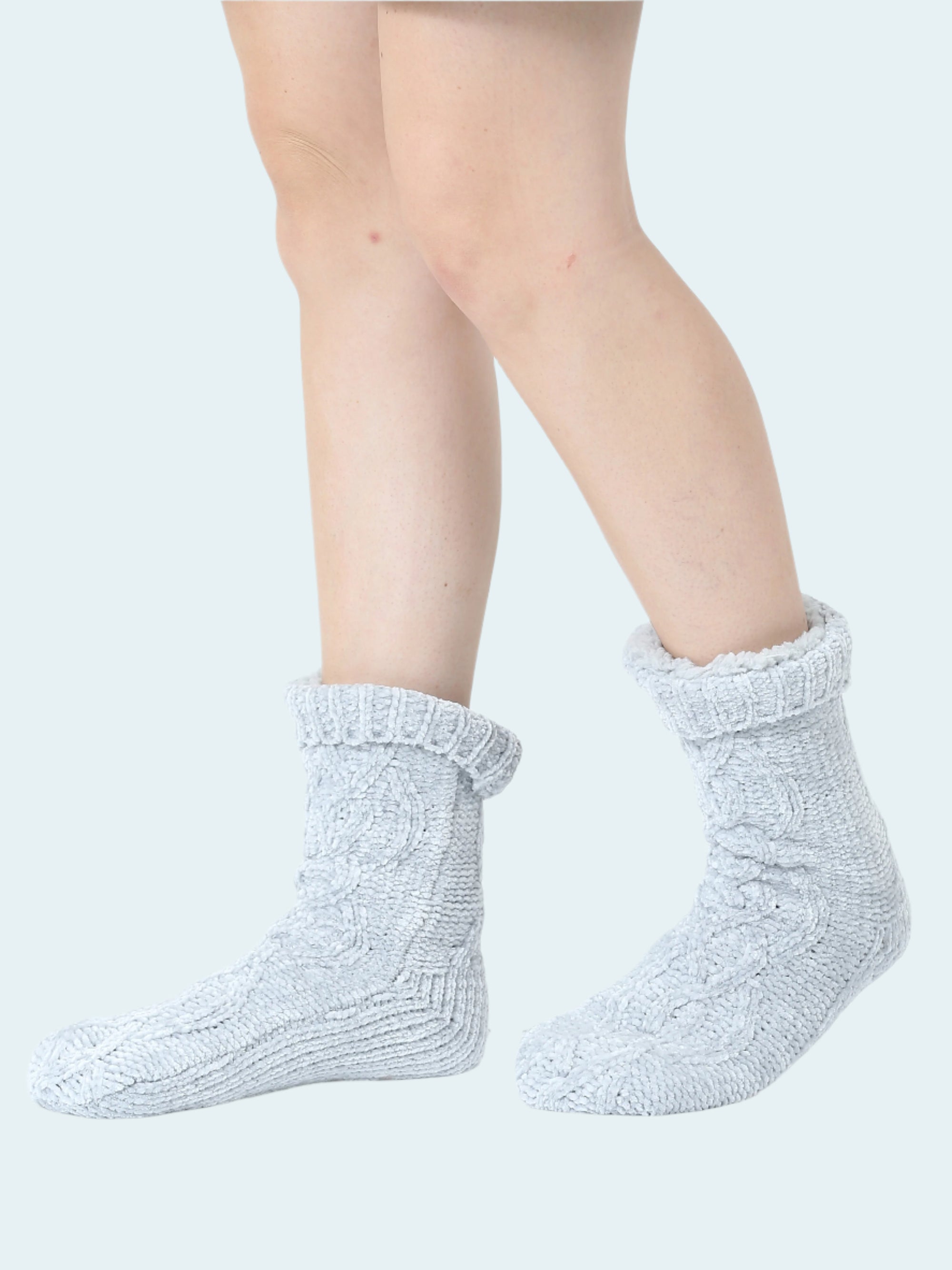 Light gray socks worn by a person on a white background
