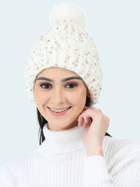 Woman wearing a white knit beanie with a pom-pom on a white background