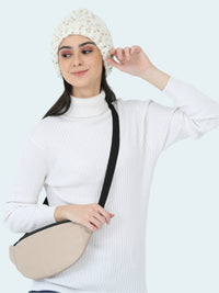 Woman wearing a white beanie and holding a beige crossbody bag against a white background