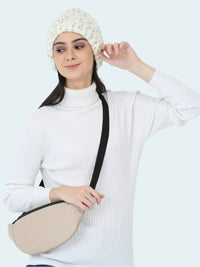 Woman wearing a white beanie and holding a beige crossbody bag against a white background