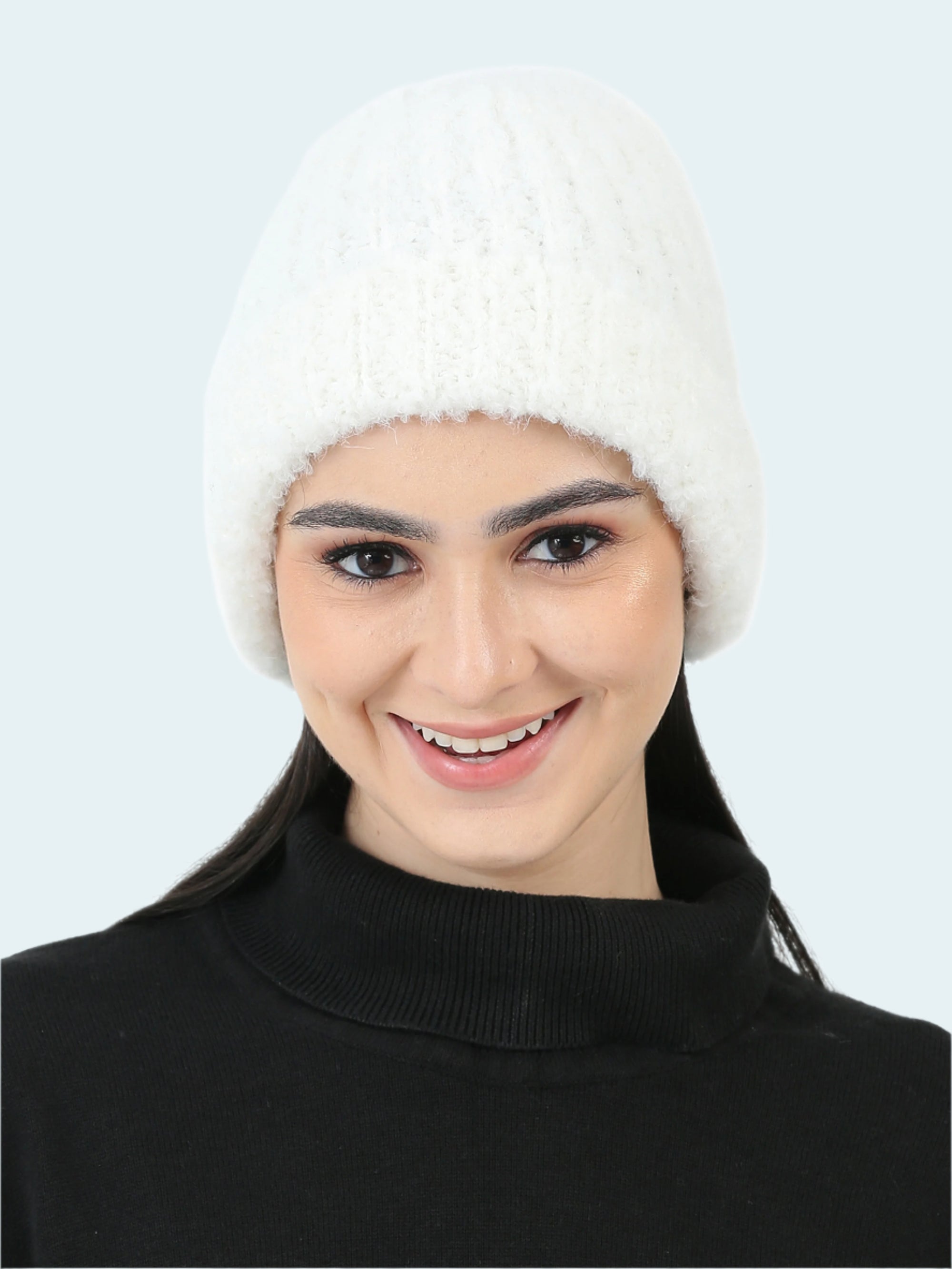 Woman wearing a white knitted hat on a white background