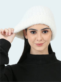 Woman wearing a white knitted hat against a white background
