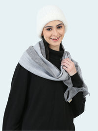Woman wearing a gray scarf and white beanie on a white background