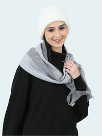 Woman wearing a gray scarf and white beanie on a white background