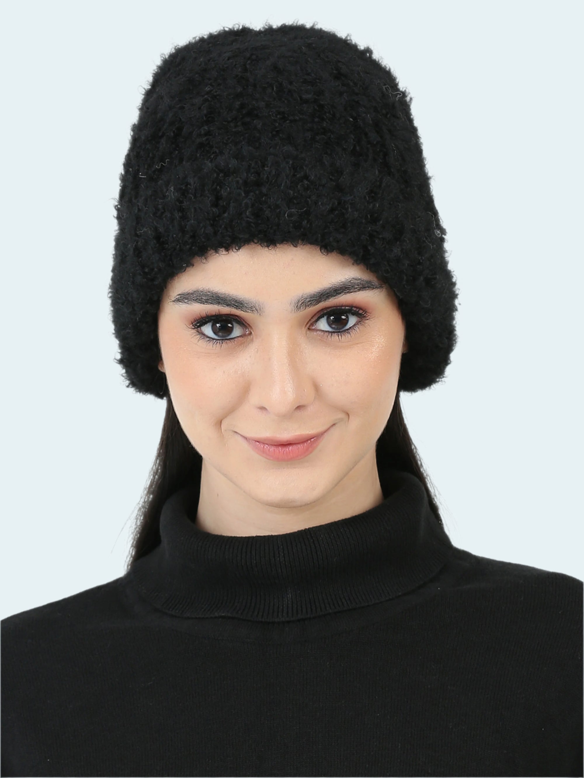 Woman wearing a black knitted hat on a white background