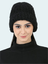 Woman wearing a black knitted hat on a white background