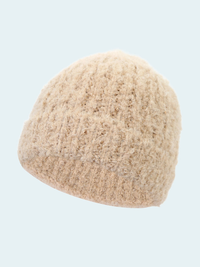 Beige knitted beanie on a white background