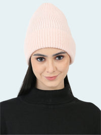 Woman wearing a pink beanie on a white background
