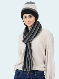 Woman wearing a striped beanie and scarf on a white background